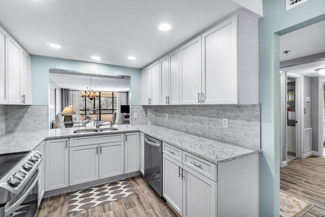 kitchen featuring light hardwood / wood-style flooring, white cabinets, stainless steel appliances, and sink