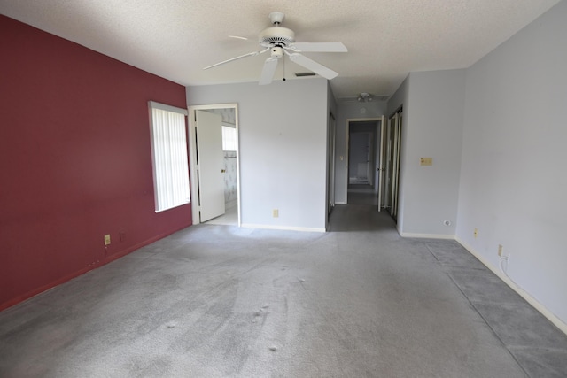 empty room featuring ceiling fan and a textured ceiling