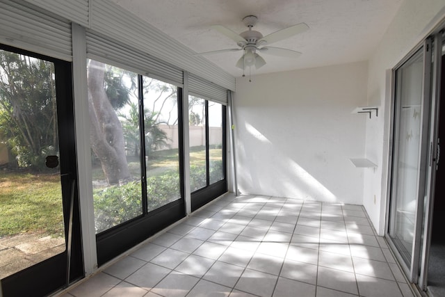 unfurnished sunroom with ceiling fan