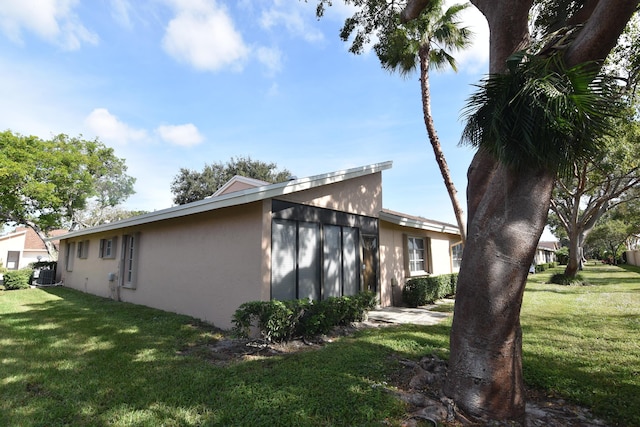 view of property exterior featuring cooling unit and a yard