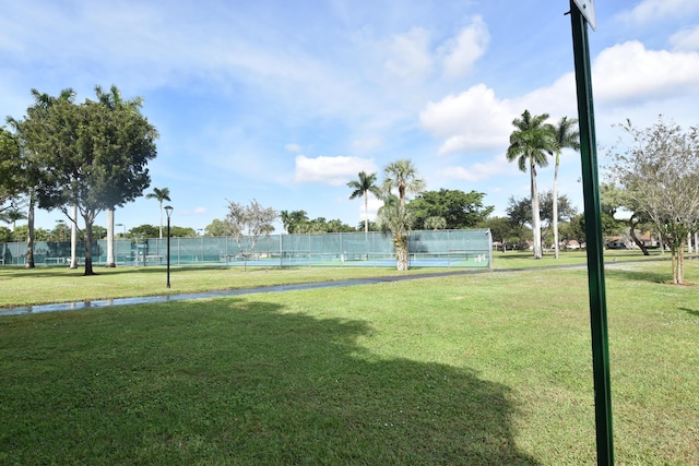 view of community featuring tennis court