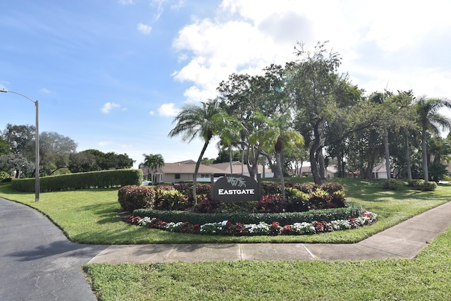 community / neighborhood sign with a lawn