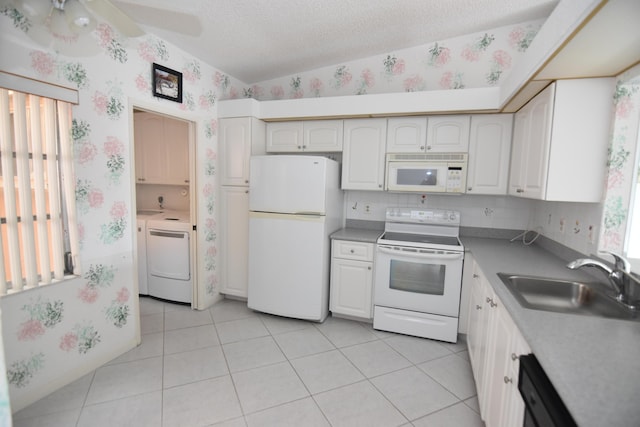 kitchen featuring white cabinetry, sink, washer / clothes dryer, a textured ceiling, and white appliances