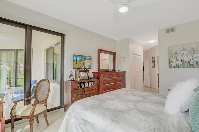 bedroom with ceiling fan, light tile patterned flooring, and a closet