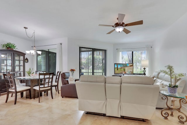 living room with ceiling fan with notable chandelier and light tile patterned flooring