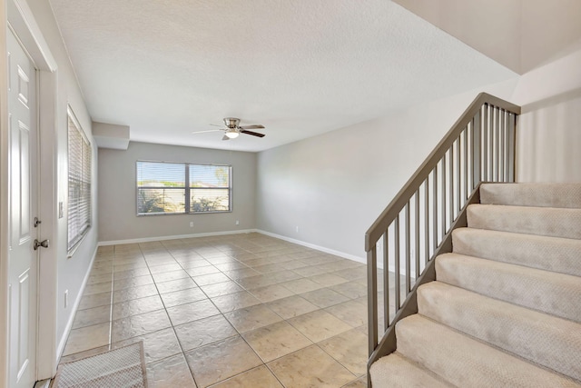 interior space featuring a textured ceiling and ceiling fan