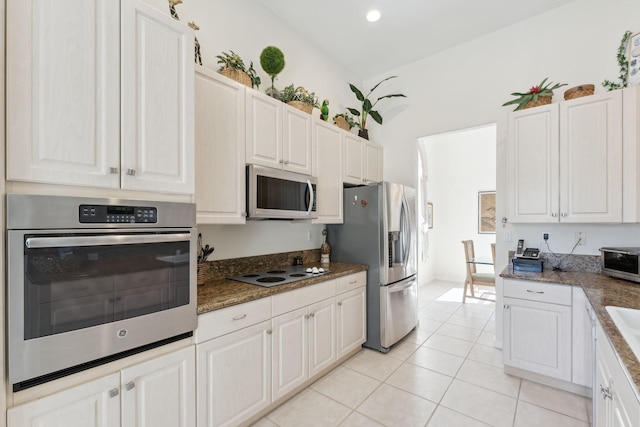 kitchen featuring white cabinets, appliances with stainless steel finishes, and light tile patterned flooring