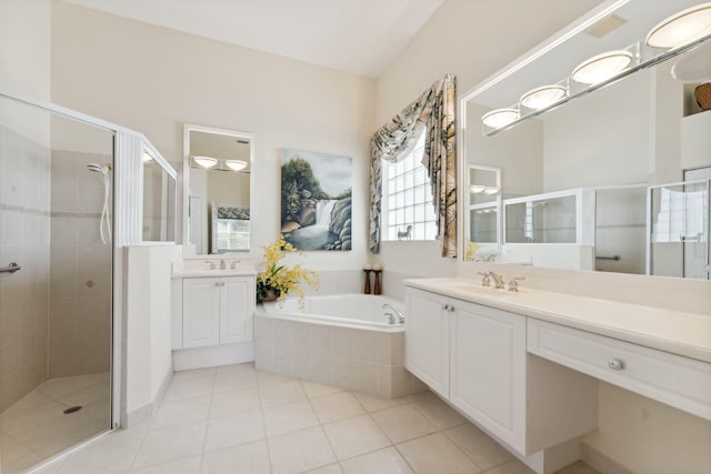 bathroom featuring shower with separate bathtub, vanity, and tile patterned floors