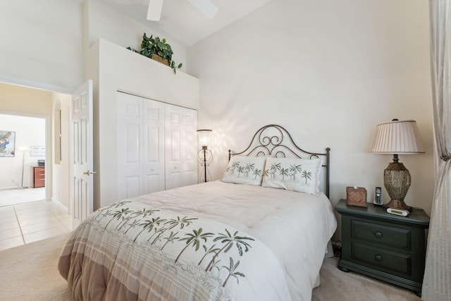 carpeted bedroom with vaulted ceiling, ceiling fan, and a closet