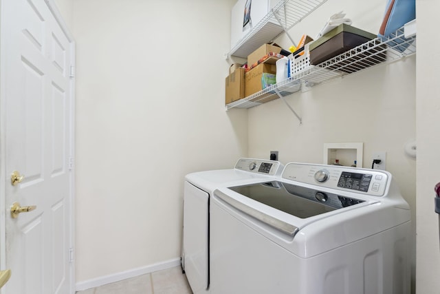 washroom featuring washer and dryer and light tile patterned floors