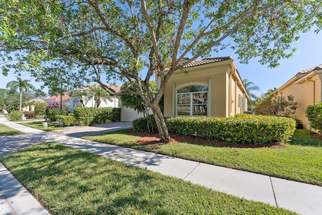 mediterranean / spanish home with a front yard