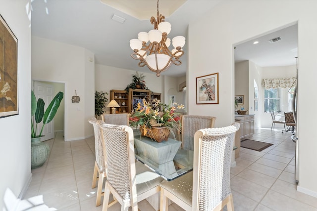 dining space with a chandelier and light tile patterned floors