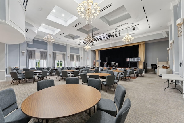 carpeted dining area with a towering ceiling, an inviting chandelier, ornamental molding, and coffered ceiling