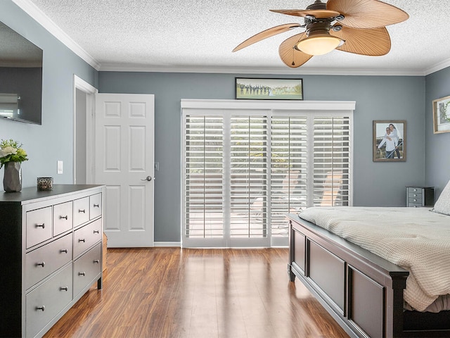 bedroom featuring hardwood / wood-style floors, ceiling fan, crown molding, and a textured ceiling