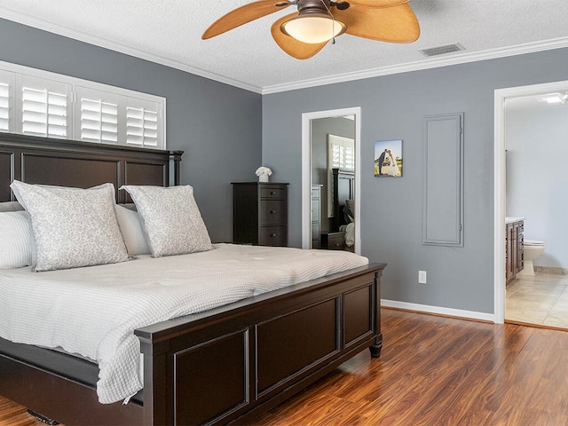 bedroom with ensuite bath, ornamental molding, a textured ceiling, ceiling fan, and dark hardwood / wood-style floors