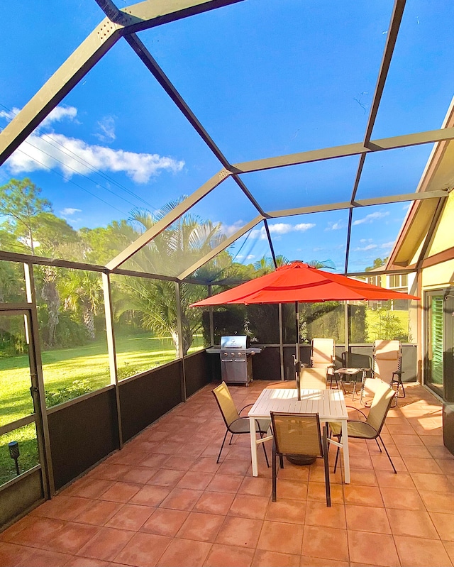 view of patio featuring glass enclosure