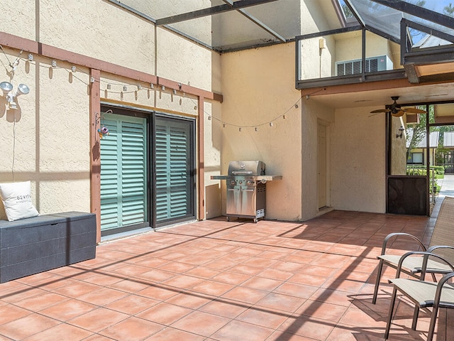 view of patio / terrace featuring grilling area, ceiling fan, and glass enclosure