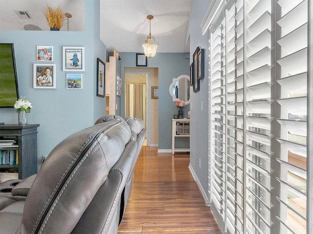 hallway with hardwood / wood-style floors