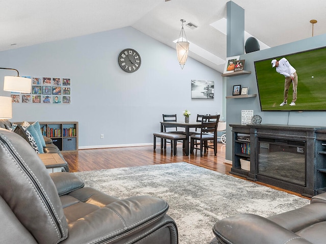 living room with hardwood / wood-style flooring and vaulted ceiling