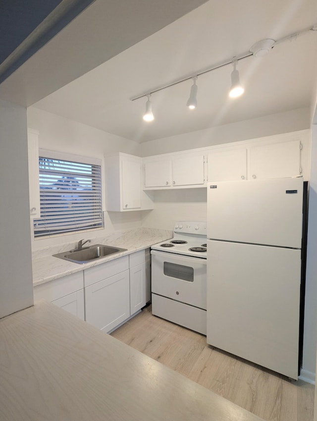 kitchen featuring white appliances, light hardwood / wood-style floors, white cabinetry, and sink