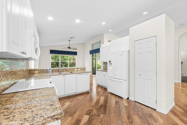 kitchen featuring lofted ceiling, white appliances, sink, light hardwood / wood-style flooring, and white cabinetry