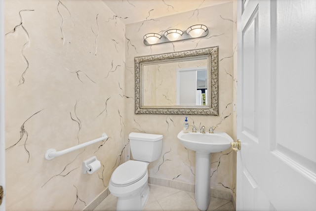 bathroom featuring tile patterned flooring, toilet, and sink