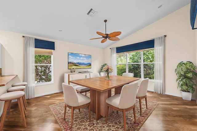 dining area featuring hardwood / wood-style floors, vaulted ceiling, and ceiling fan