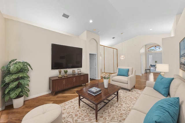 living room with light hardwood / wood-style floors and lofted ceiling