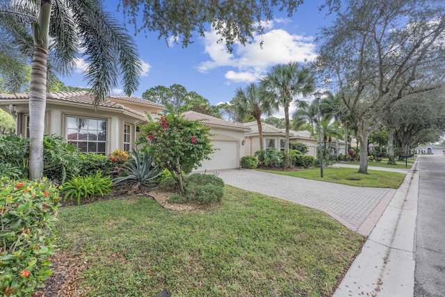 view of front of home with a front lawn and a garage