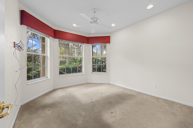 spare room with carpet and ceiling fan