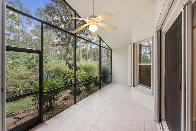 unfurnished sunroom featuring ceiling fan and lofted ceiling