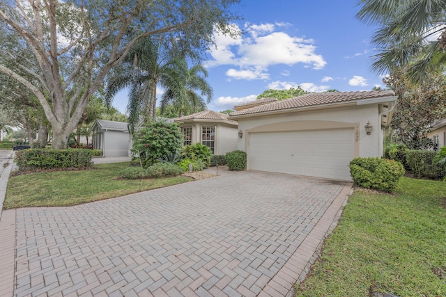 11056 Manele Ct, Boynton Beach, FL 33437 - view of front of house featuring a tile roof, a garage, decorative driveway, and stucco siding