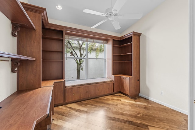 unfurnished office featuring ceiling fan and light wood-type flooring