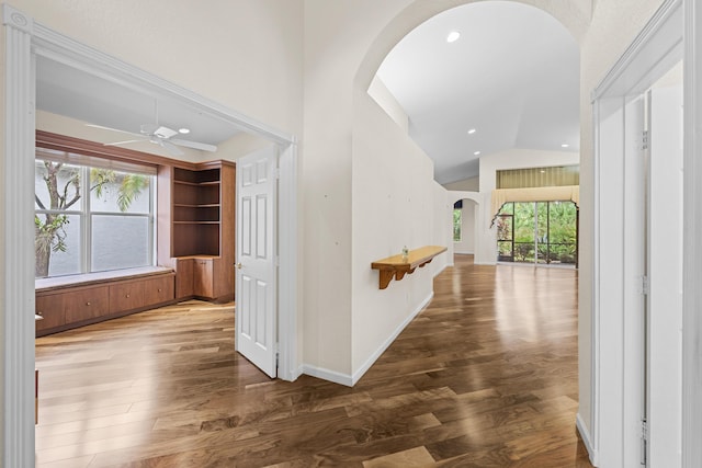 11056 Manele Ct, Boynton Beach, FL 33437 - hallway with baseboards, arched walkways, recessed lighting, wood finished floors, and high vaulted ceiling