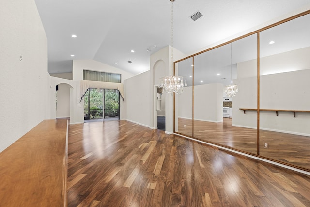 interior space with high vaulted ceiling, a chandelier, and hardwood / wood-style flooring