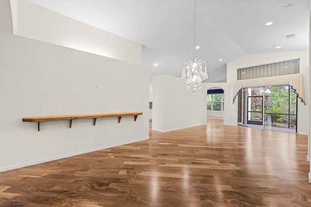 unfurnished living room featuring hardwood / wood-style floors and high vaulted ceiling