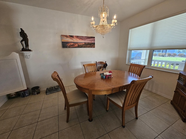 tiled dining room with an inviting chandelier