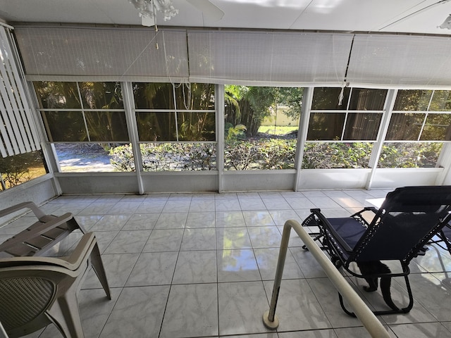 sunroom / solarium featuring ceiling fan