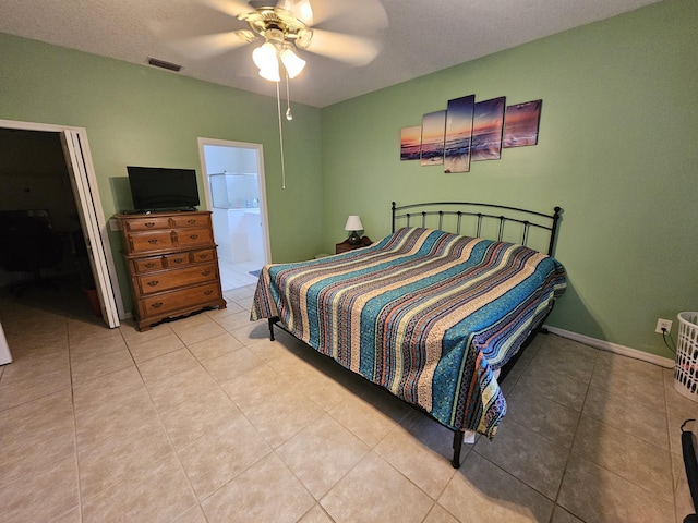 bedroom featuring ceiling fan, light tile patterned floors, and connected bathroom