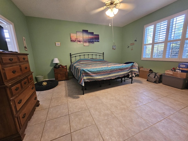 tiled bedroom with ceiling fan