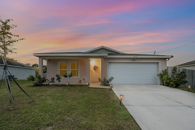 single story home with a garage and a yard