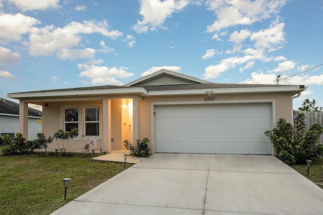 ranch-style house with a garage and a front yard