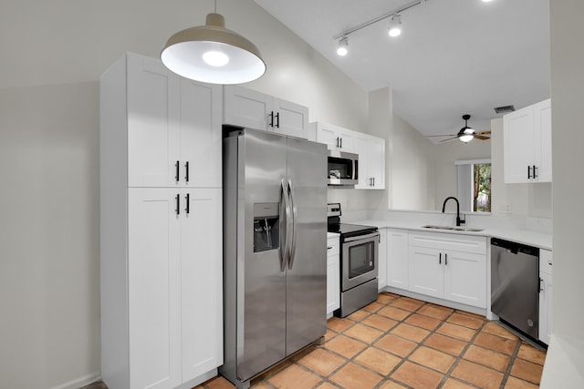 kitchen featuring appliances with stainless steel finishes, ceiling fan, sink, white cabinetry, and lofted ceiling