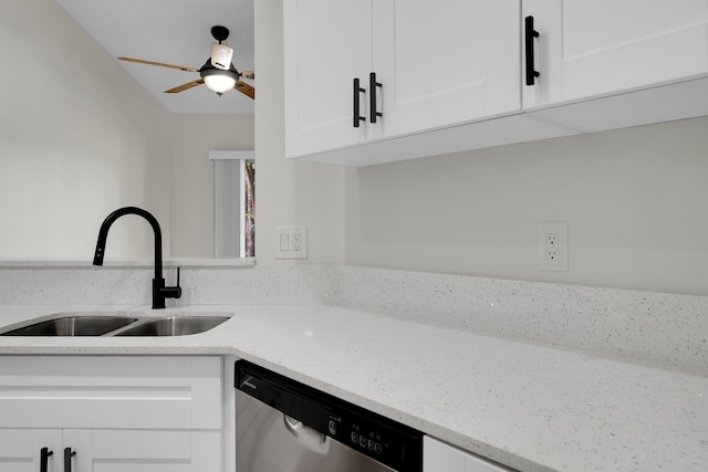 kitchen with white cabinets, light stone counters, stainless steel dishwasher, and sink