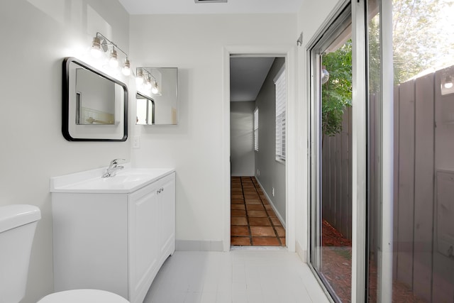 bathroom featuring tile patterned flooring, vanity, and toilet