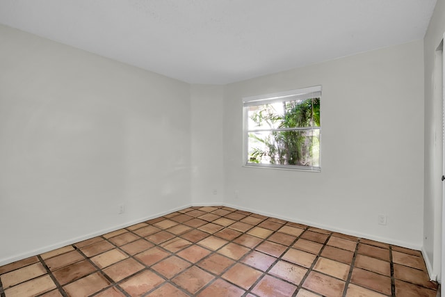 unfurnished room featuring tile patterned flooring