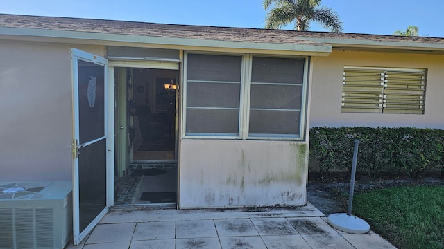 doorway to property featuring central AC unit