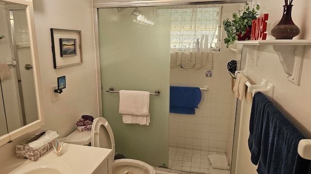 bathroom with an enclosed shower, vanity, and toilet