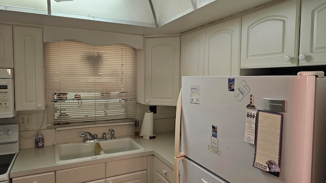 kitchen featuring white cabinets, white appliances, backsplash, and sink