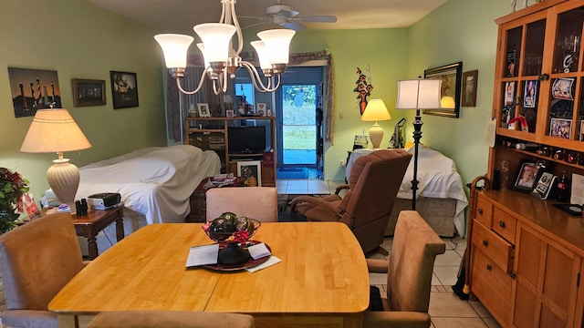 dining room featuring light tile patterned floors and ceiling fan with notable chandelier